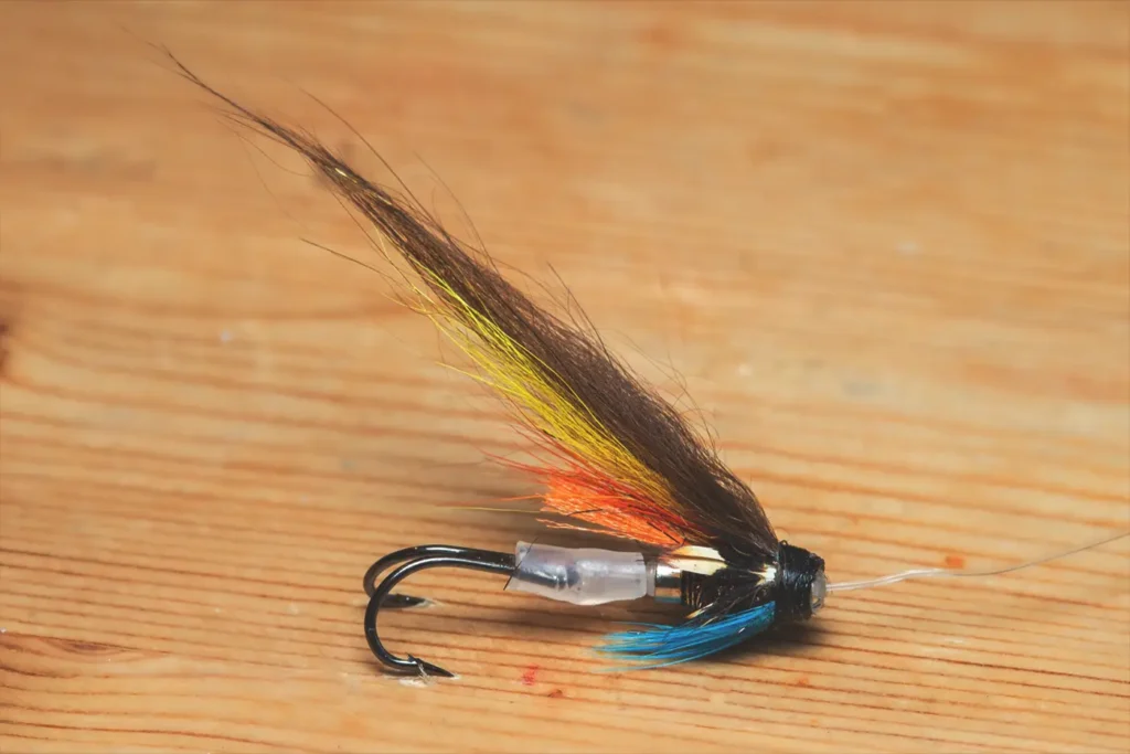 Three salmon flies that were probably homemade on the cork handle