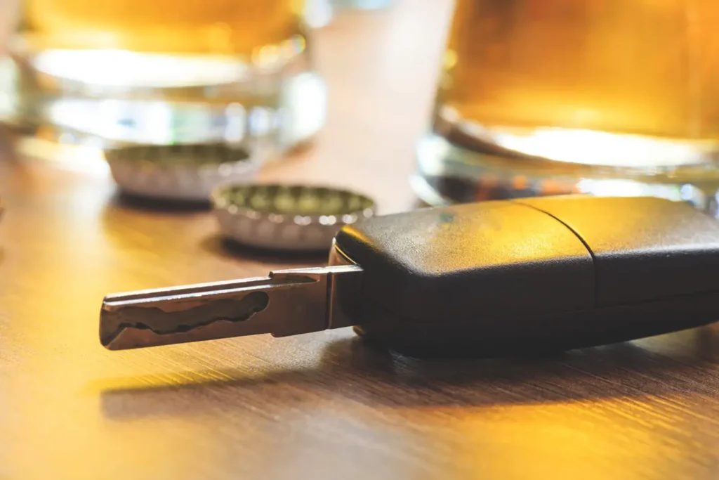 Beer bottles on a table, conveying information about the presence of a car key.