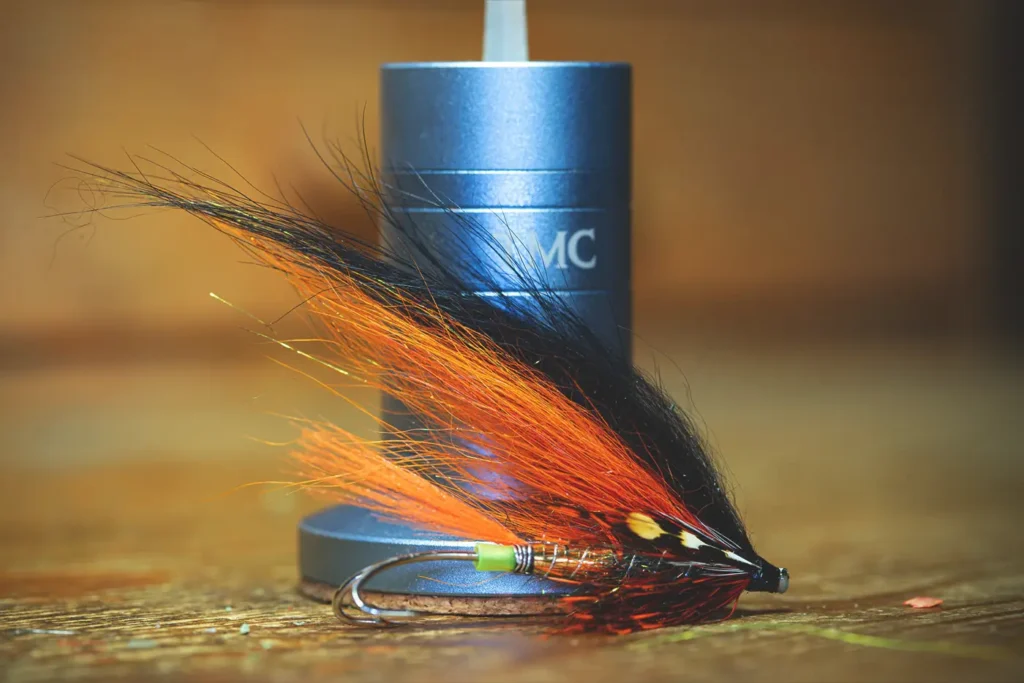 A classic fly, resembling the Gaula flies, perched on a wooden table.