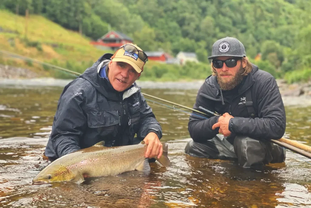 Two anglers showcasing their successful catch during a Gaula fishing expedition.