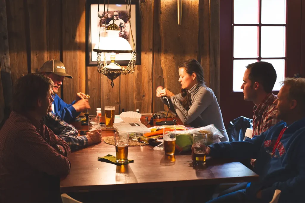 A group of people exchanging information while sitting around a table.