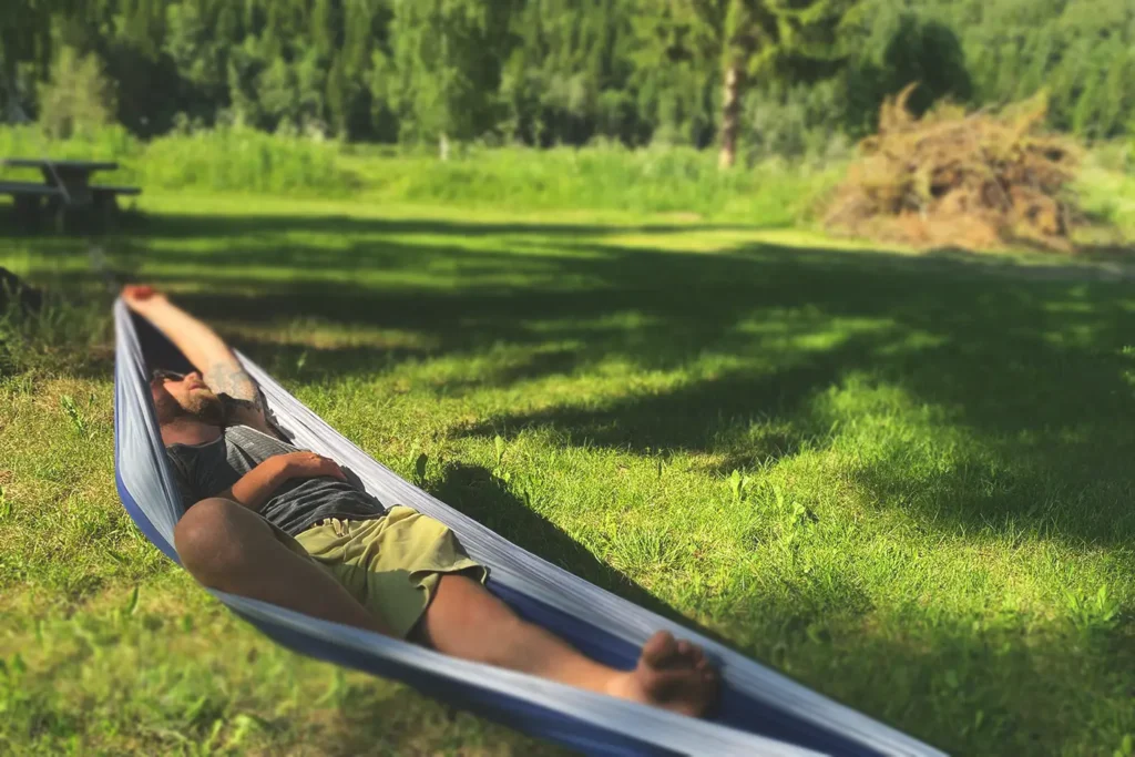 A man enjoying relaxation in a hammock.